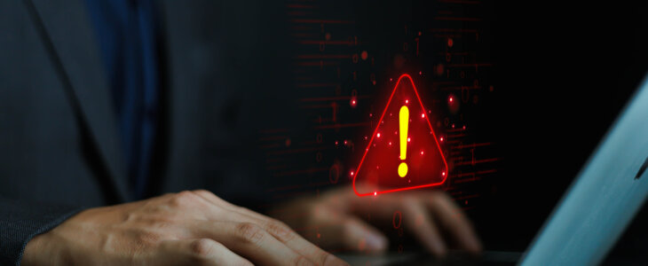 Cyber ​​attack alert on laptop. Cyber ​​attack on computer network. Virus, spyware, malware or malicious software. Businessman background.