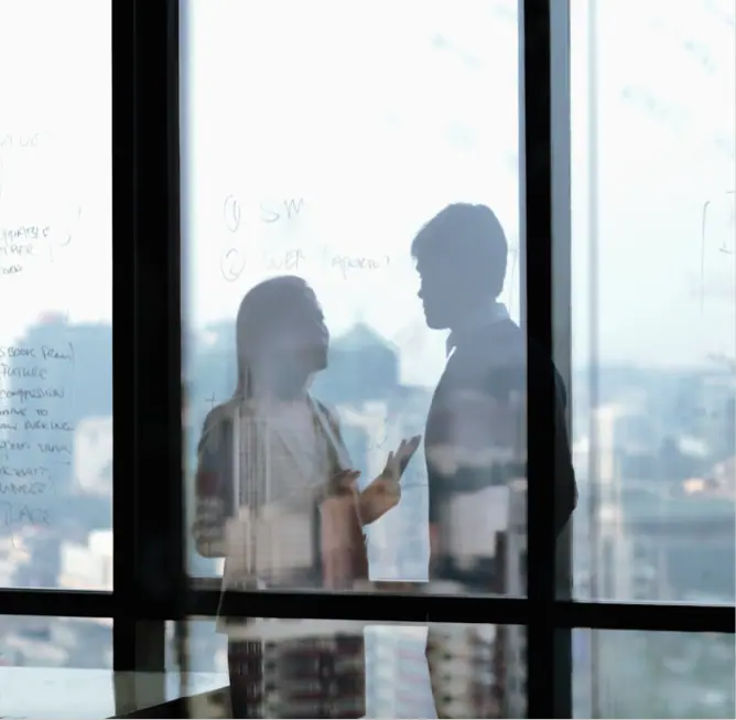 Man and woman having discussion in an office building
