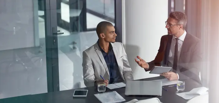 Two business partners talking at a table