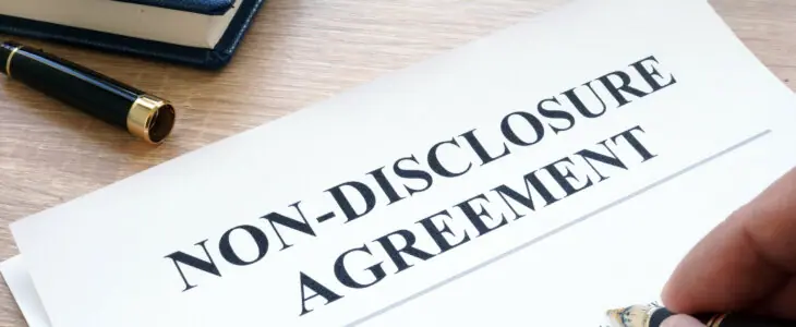 Man is filling in Non-Disclosure Agreement NDA.